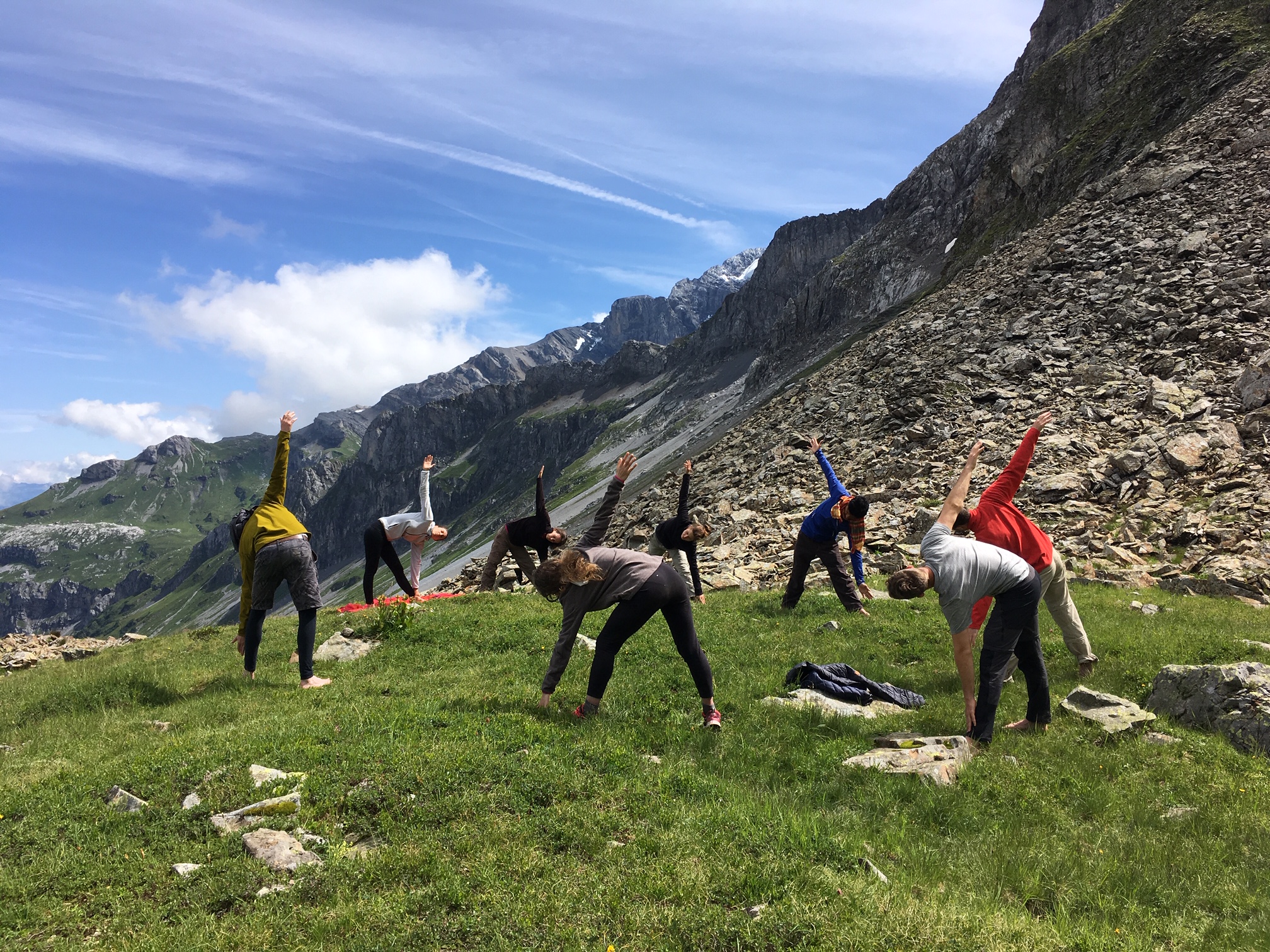 people doing yoga in the mountains
