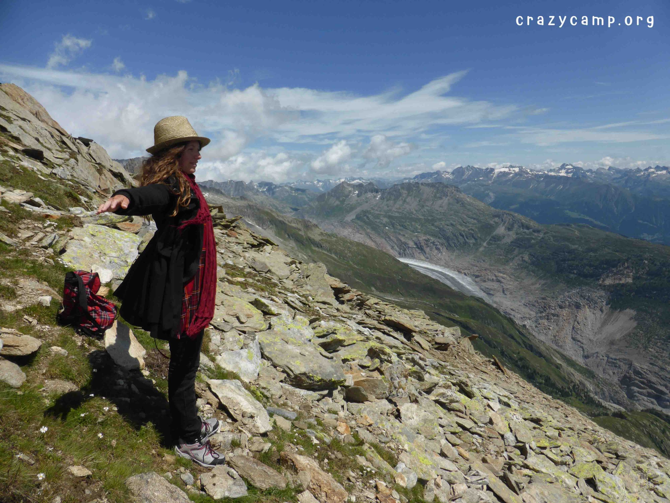 A photo of a woman enjoying an incredibly beautiful alpine panorama during a group hike
